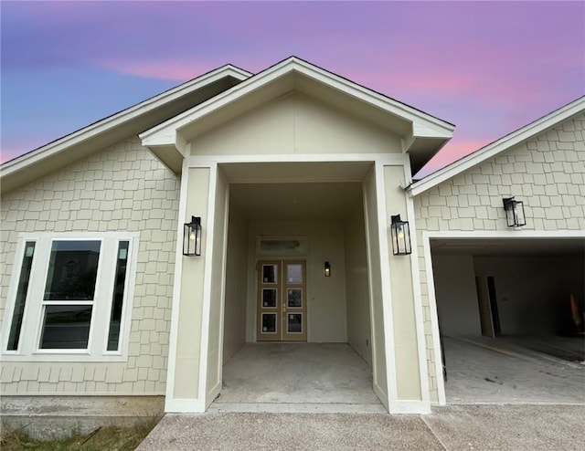 13817 Hawksnest Bay Dr, Corpus Christi, TX 78418 - exterior entry at dusk featuring an attached garage