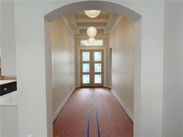 13817 Hawksnest Bay Dr, Corpus Christi, TX 78418 - doorway featuring a tray ceiling, arched walkways, french doors, and a chandelier