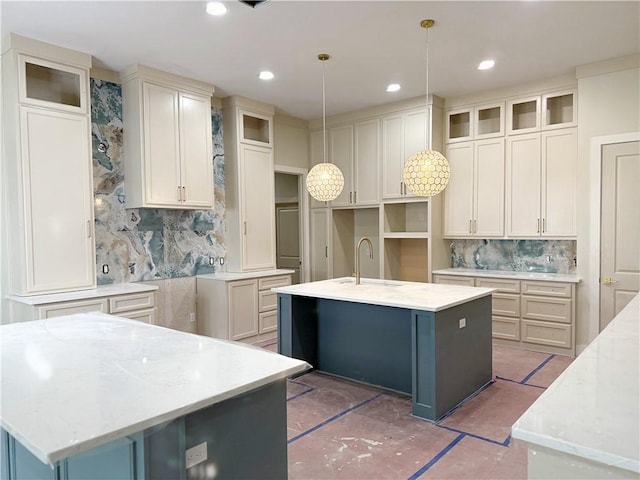 13817 Hawksnest Bay Dr, Corpus Christi, TX 78418 - kitchen with a center island with sink, decorative backsplash, light stone countertops, and recessed lighting