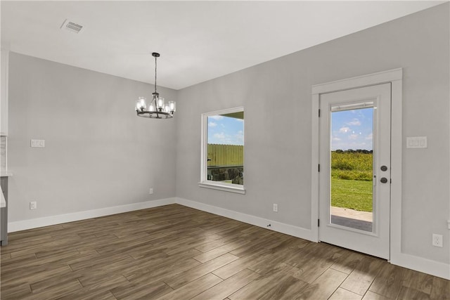 6218 Sadie St, Corpus Christi, TX 78415 - unfurnished dining area with a chandelier, wood finished floors, and plenty of natural light