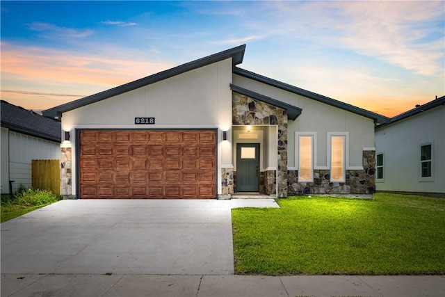 6218 Sadie St, Corpus Christi, TX 78415 - contemporary home featuring stone siding, a garage, driveway, a yard, and stucco siding