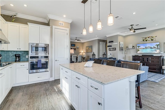 kitchen featuring ceiling fan, white cabinetry, and appliances with stainless steel finishes