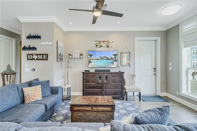 living room featuring ceiling fan, light wood-type flooring, and ornamental molding