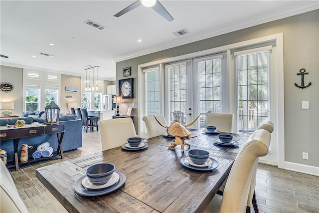 dining room featuring ceiling fan, crown molding, and french doors