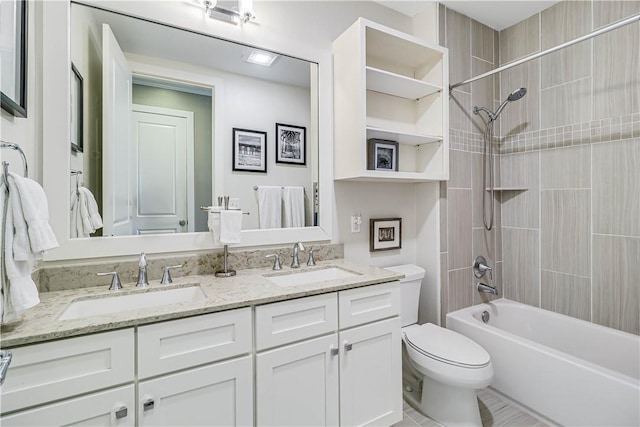 full bathroom with toilet, vanity, and tiled shower / bath