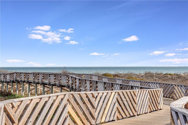 view of property's community featuring a beach view and a water view