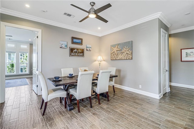 dining room with hardwood / wood-style flooring, ceiling fan, and crown molding