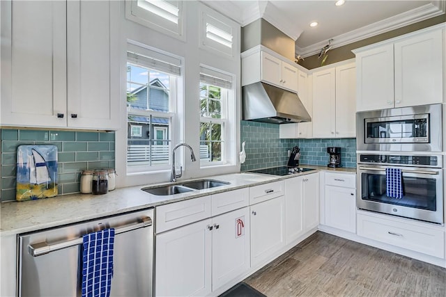 kitchen featuring light stone countertops, sink, stainless steel appliances, tasteful backsplash, and white cabinets