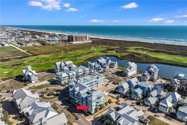 bird's eye view with a water view and a beach view