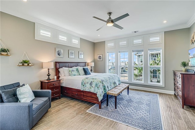 bedroom with light wood-type flooring, ceiling fan, and crown molding