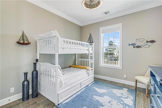 bedroom with hardwood / wood-style flooring and ornamental molding