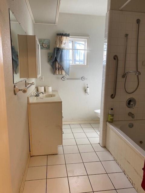 full bathroom featuring toilet, tiled shower / bath combo, tile patterned floors, crown molding, and vanity