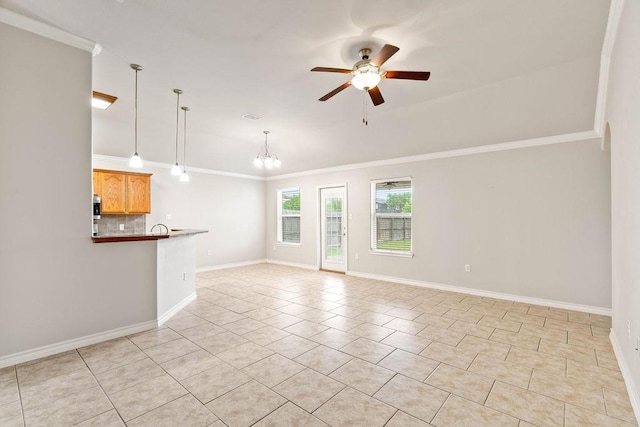 1201 Cline St, Corpus Christi, TX 78418 - unfurnished living room featuring ceiling fan, crown molding, a chandelier, baseboards, and light tile patterned floors