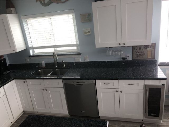 kitchen featuring dishwasher, white cabinets, beverage cooler, and sink