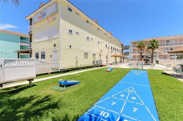 view of community with a yard and a patio