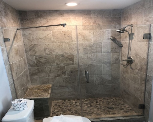 bathroom featuring toilet and walk in shower