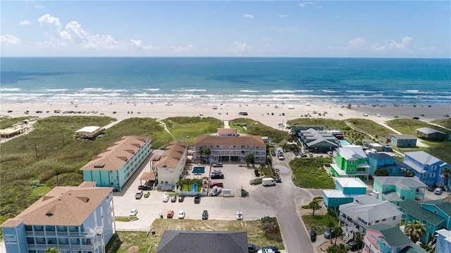 bird's eye view featuring a water view and a beach view