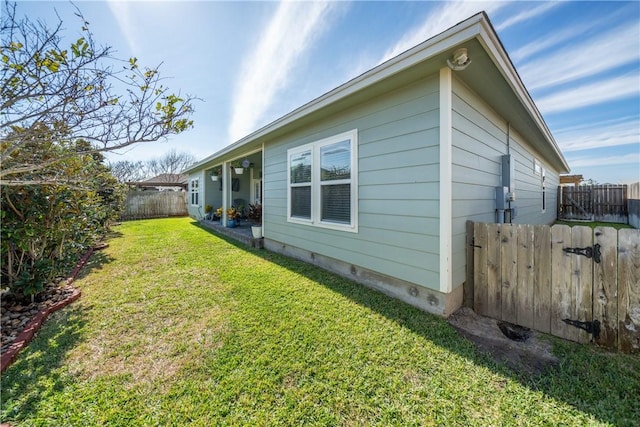 back of house with a yard, crawl space, and a fenced backyard