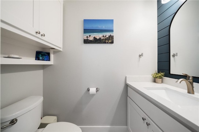 bathroom featuring a water view, vanity, and toilet