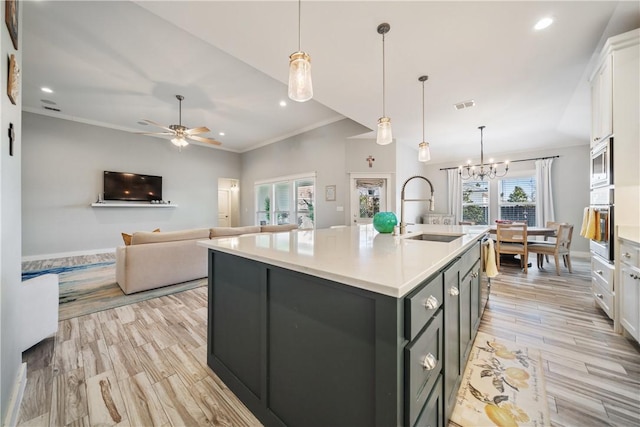 kitchen with light countertops, visible vents, appliances with stainless steel finishes, white cabinets, and a sink