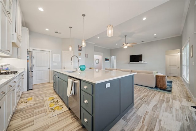 kitchen featuring stainless steel appliances, light countertops, visible vents, white cabinets, and a sink