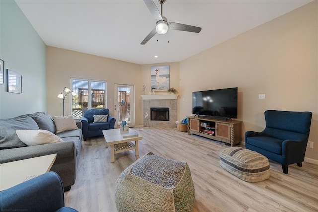 15414 Salt Cay Ct Unit 5E, Corpus Christi, TX 78418 - living area featuring a ceiling fan, baseboards, a tiled fireplace, and light wood-style flooring