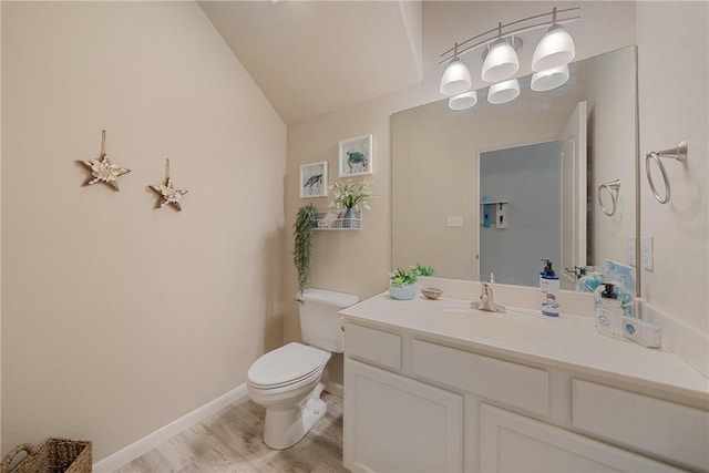 15414 Salt Cay Ct Unit 5E, Corpus Christi, TX 78418 - bathroom featuring lofted ceiling, toilet, baseboards, vanity, and wood finished floors