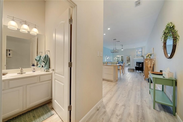 15414 Salt Cay Ct Unit 5E, Corpus Christi, TX 78418 - hallway with a sink, light wood-type flooring, visible vents, recessed lighting, and baseboards