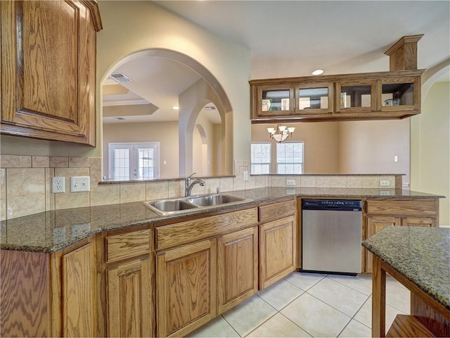 kitchen with a sink, visible vents, brown cabinetry, and dishwasher