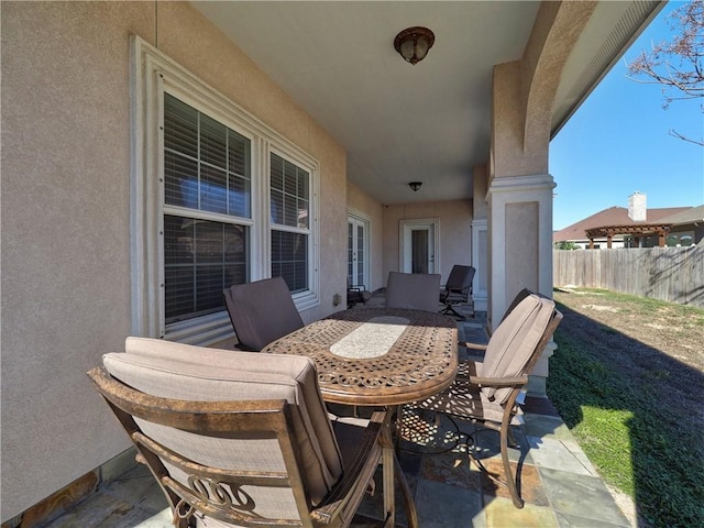 view of patio / terrace featuring fence and outdoor dining area