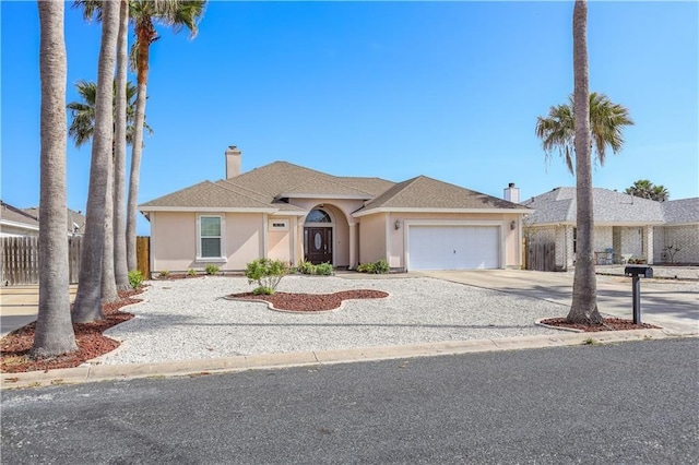 view of front of house featuring fence, stucco siding, a chimney, concrete driveway, and an attached garage