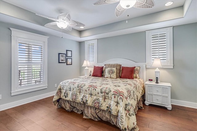 bedroom with dark hardwood / wood-style floors and ceiling fan