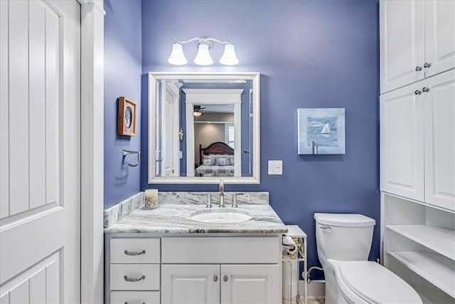 bathroom featuring ceiling fan, vanity, and toilet