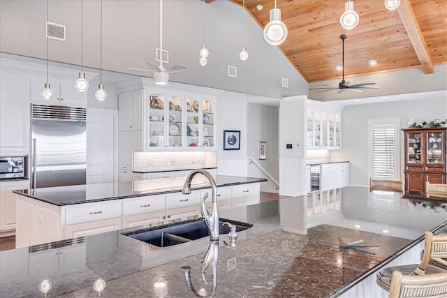 kitchen with decorative light fixtures, stainless steel appliances, white cabinetry, and wooden ceiling