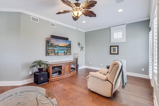 living room featuring ceiling fan, wood-type flooring, and ornamental molding