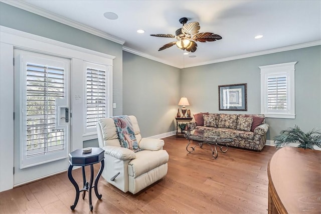 living room with ceiling fan, light hardwood / wood-style floors, and crown molding