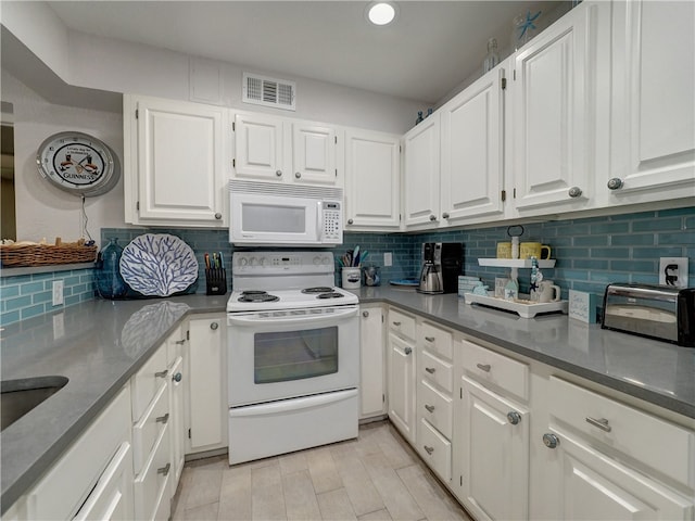 kitchen featuring white appliances, white cabinetry, and decorative backsplash