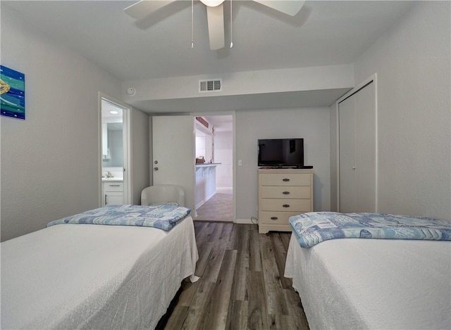 bedroom featuring ensuite bathroom, ceiling fan, dark hardwood / wood-style floors, and a closet