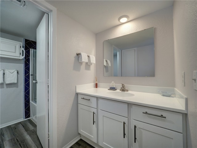 bathroom with vanity, hardwood / wood-style flooring, and  shower combination