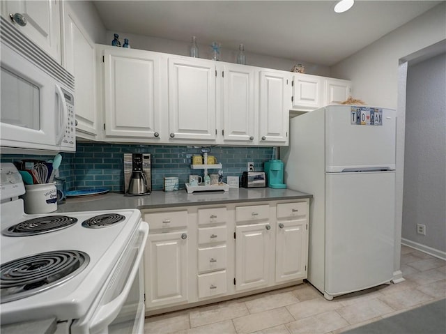 5973 State Highway 361 Unit 218, Port Aransas, TX 78373 - kitchen with white appliances, white cabinets, decorative backsplash, and light countertops