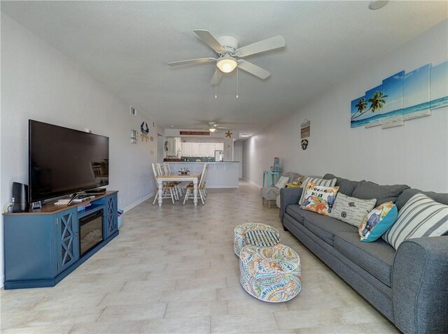 5973 State Highway 361 Unit 218, Port Aransas, TX 78373 - living room featuring ceiling fan and baseboards