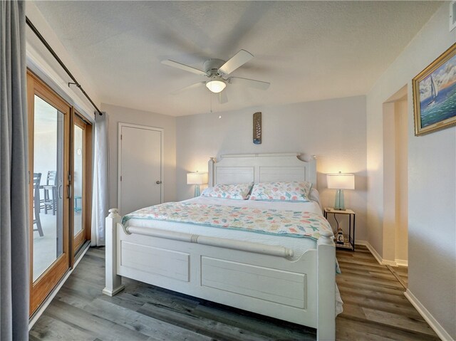 bedroom with dark wood-type flooring, ceiling fan, a textured ceiling, and access to outside