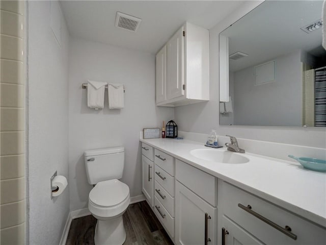 5973 State Highway 361 Unit 218, Port Aransas, TX 78373 - bathroom with wood finished floors, toilet, vanity, baseboards, and a shower with curtain