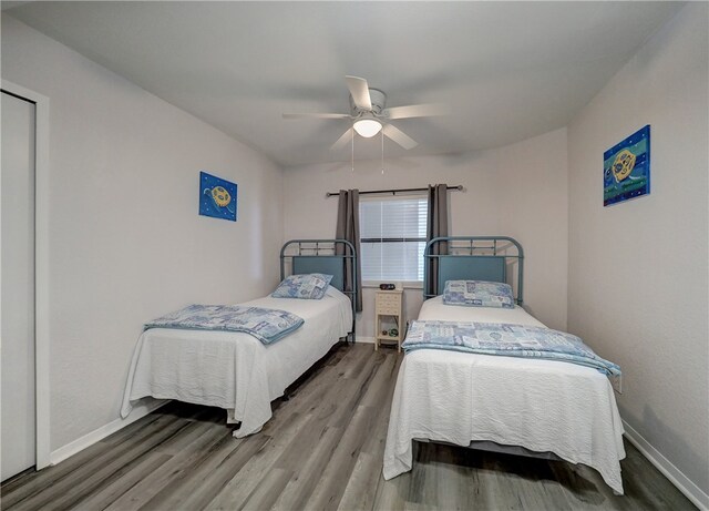 bedroom featuring wood-type flooring and ceiling fan