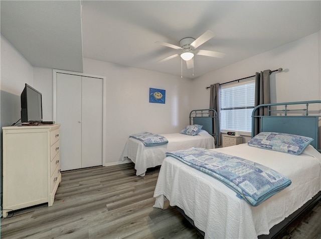 bedroom with hardwood / wood-style floors, ceiling fan, and a closet