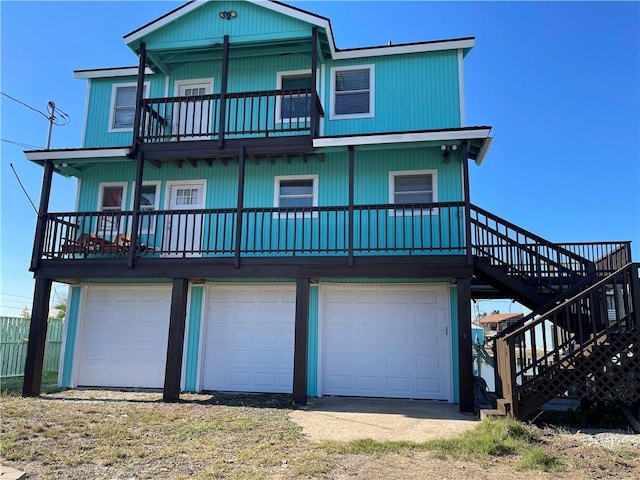 back of house with a balcony and a garage