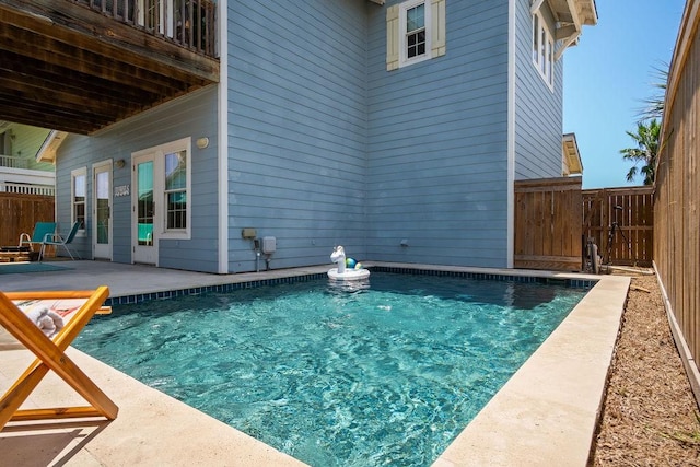 view of swimming pool with a patio, a fenced backyard, and a fenced in pool