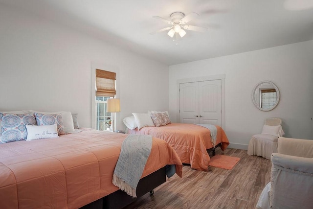 bedroom with baseboards, a closet, a ceiling fan, and wood finished floors