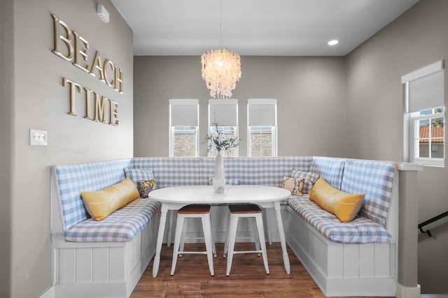 sitting room with recessed lighting, wood finished floors, and an inviting chandelier