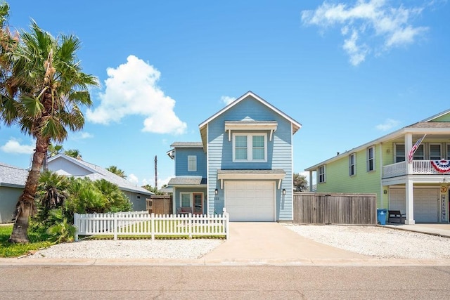 view of front of property with a garage, a fenced front yard, and concrete driveway